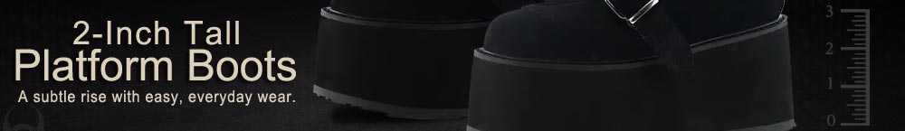 Black ankle boots with a 2-inch platform and buckle straps on a studio background.