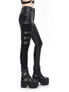 Side view of women's black punk pants with buckles and a fitted design, paired with platform boots.