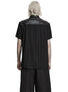 Back view of a black short sleeve shirt with plaid collar and layered hem.