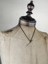 Close-up of Bushido Pendant Necklace with a black chain and sword-shaped pendant on a mannequin bust