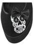 Close-up of CLICK-02-3 Skull Platform Shoes with embroidered white skull and black bow on black upper