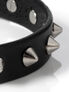 Black leather choker with silver cone spikes and metal studs on a white background