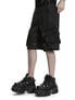 Black utility cargo shorts with side pockets worn with chunky black platform shoes