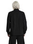 Back view of a black long sleeve button-up shirt on a man with light hair