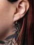 Close-up of a person's ear wearing Gothic bat dropper earrings with intricate design.