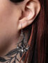 Lunar Moth dropper earrings displayed on a model's ear, featuring intricate metalwork and a pearl.