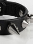 Black leather wristband with silver metal spikes and a buckle closure
