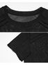 Black mesh shirt with short sleeves and ribbed shoulder detail on a white background