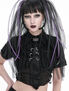 A model wearing a black cropped top with lace-up details and long black and purple hair extensions.