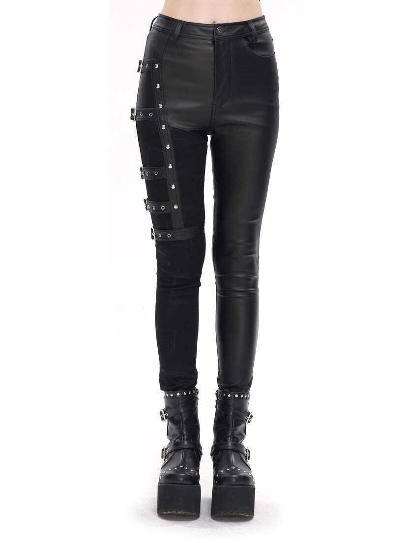 Black women's punk pants with studded details and a fitted design, paired with chunky black boots.
