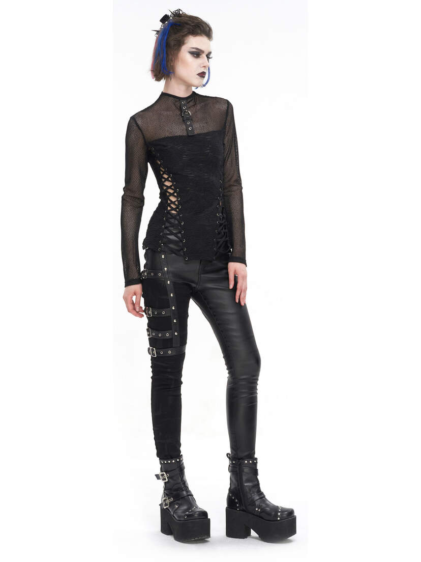 A model wearing black alternative punk pants with a sheer top and platform boots.