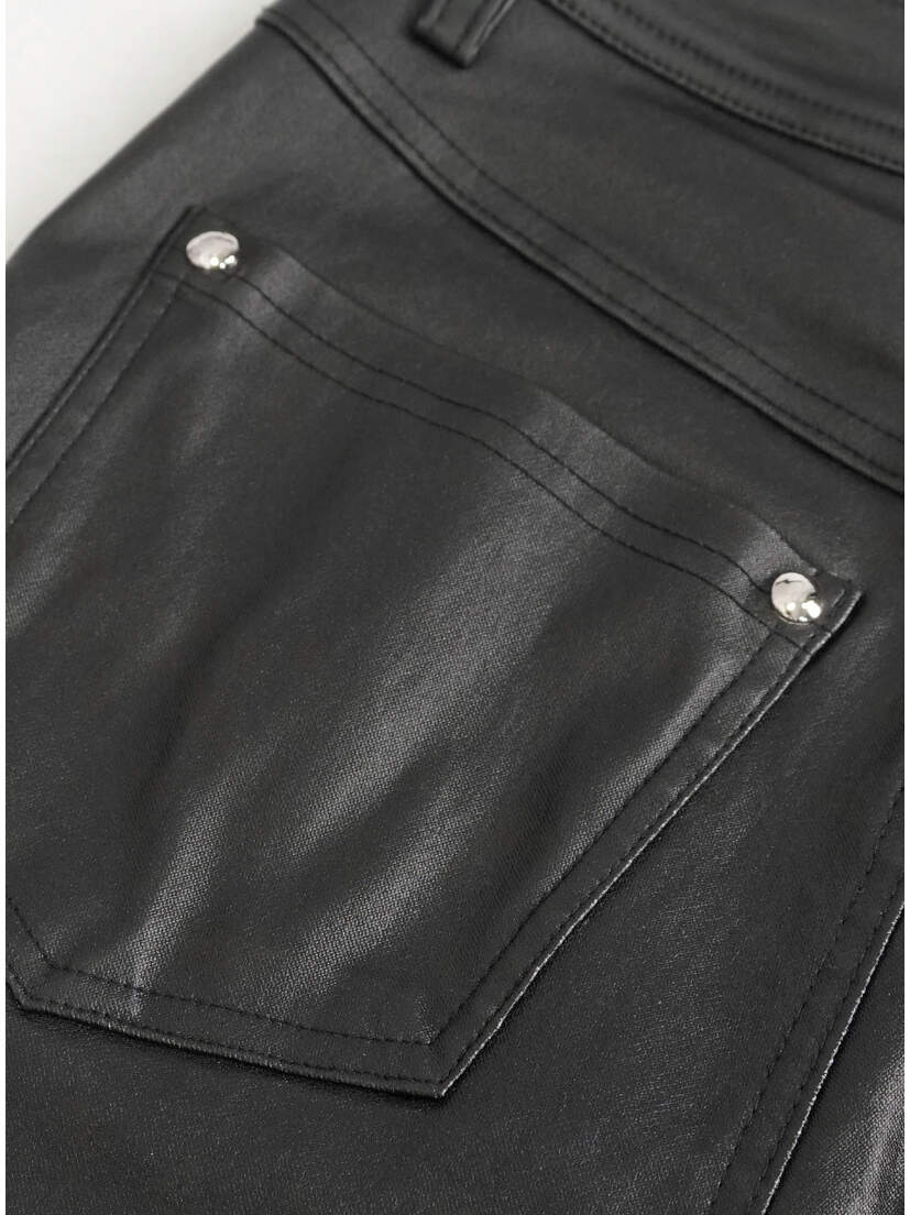 Close-up of a black pocket on women's alternative punk pants with silver studs.
