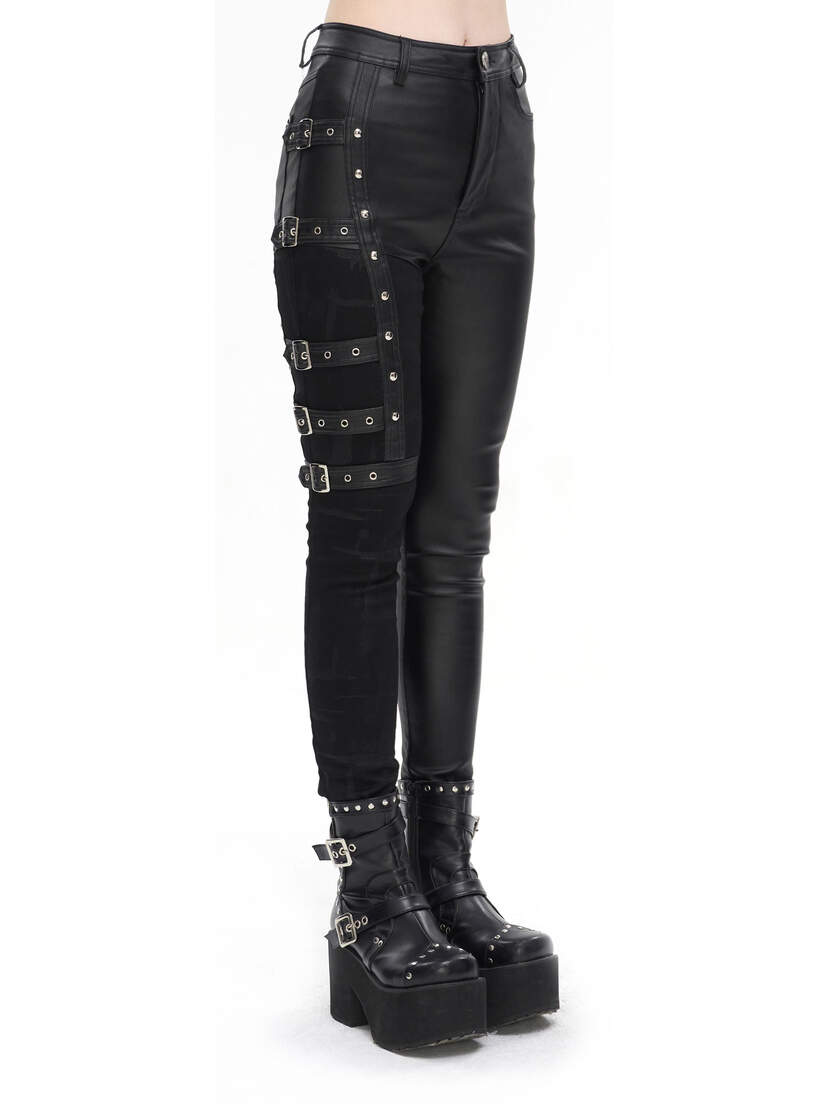 Black women's punk pants with buckle details and a slim fit, paired with chunky platform boots.