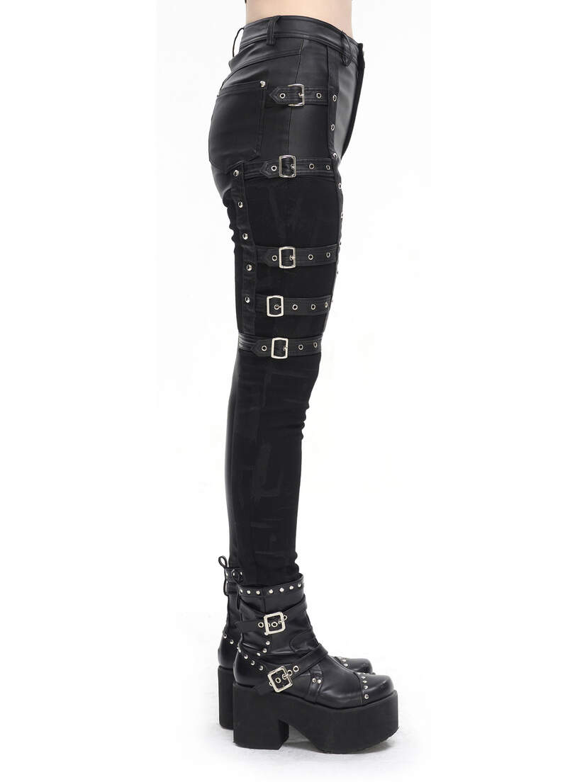 Side view of women's black punk pants with buckles and straps, paired with platform boots.