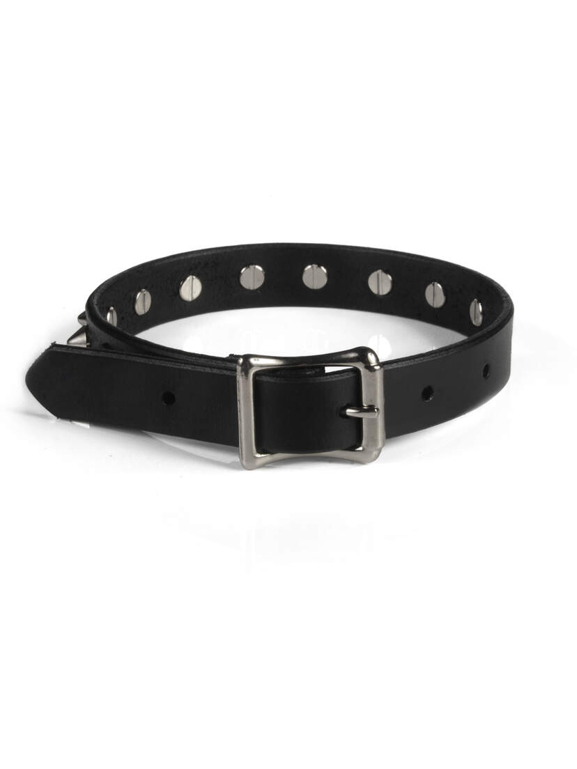 Black leather choker with silver cone spikes and a buckle closure on a white background
