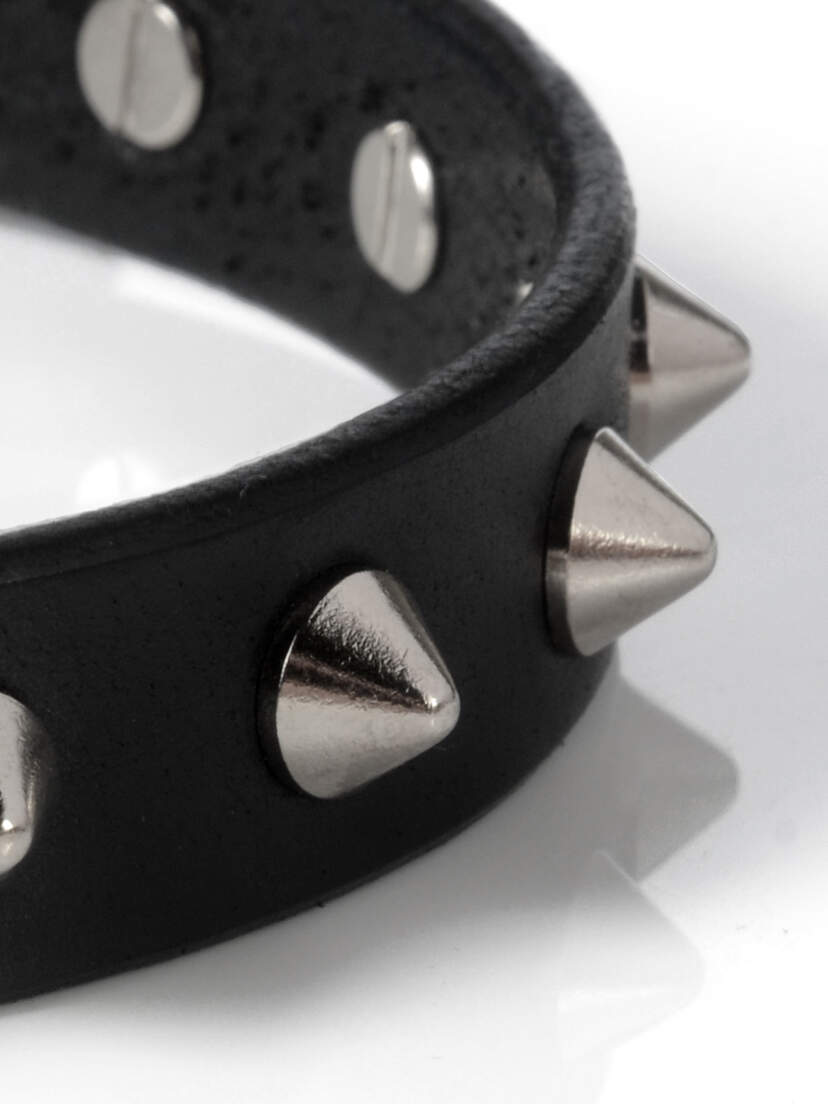 Black leather choker with silver cone spikes and metal studs on a white background