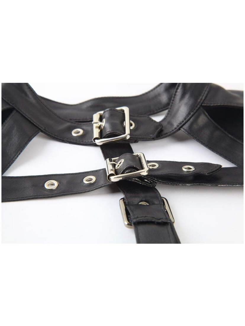 Close-up of Fated long sleeve harness in black faux leather with silver buckles and grommet details