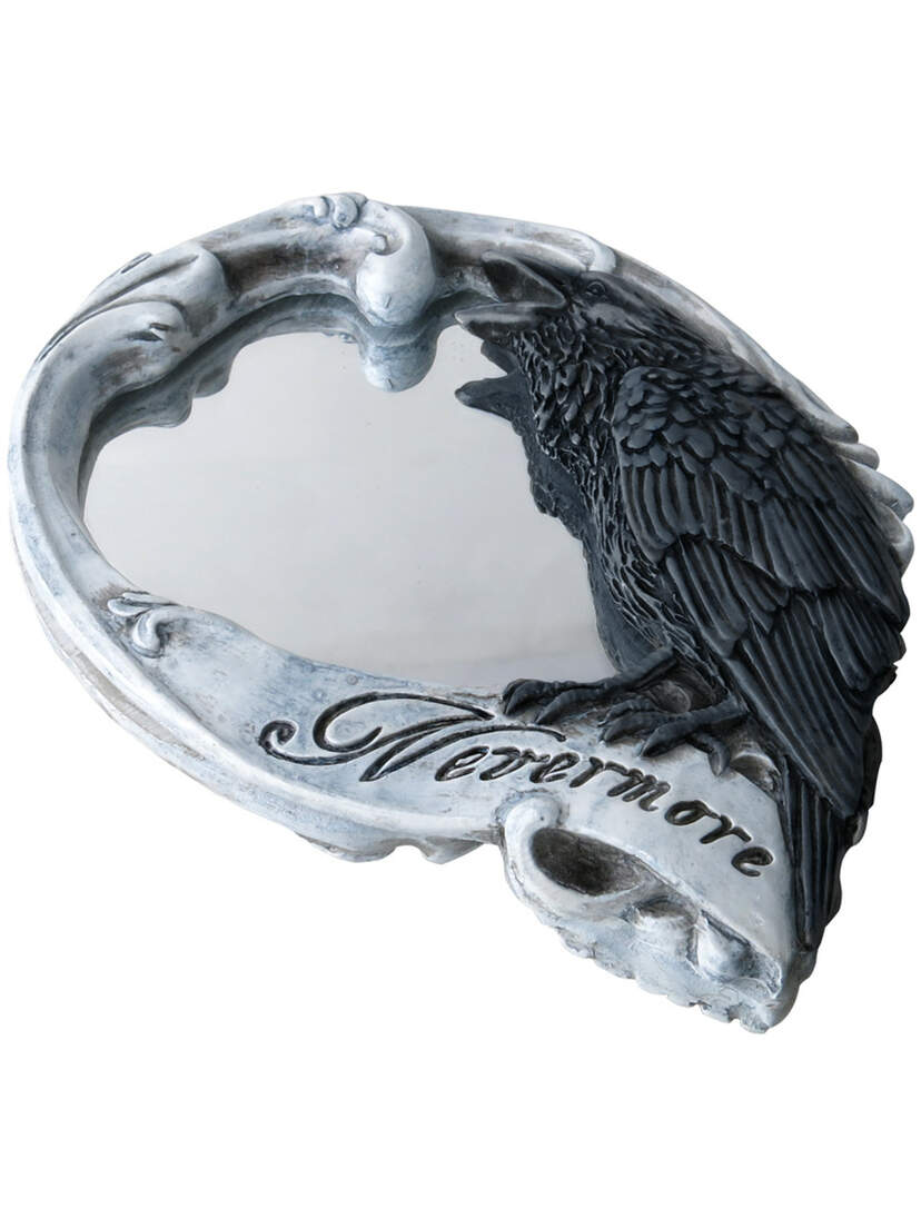 Close-up of Gothic Raven Nevermore Compact Mirror with silver frame, black raven wing design, and engraved text