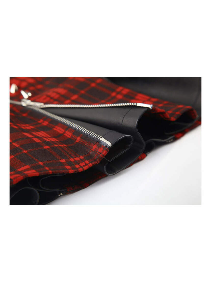Close-up of Punk Rock Tartan Skirt in red plaid fabric with silver zipper and black trim detail