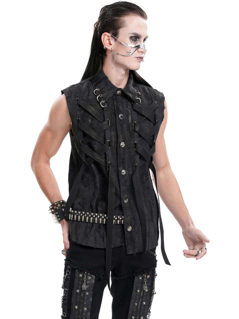 Shadow Piercer Button-up Vest A model wearing a black button-up vest with decorative straps and studs, styled with dark pants.