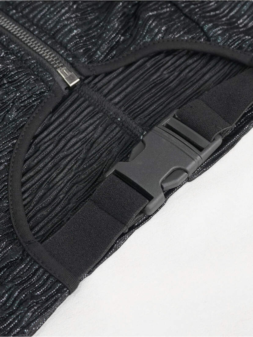 Violet Top - Women’s Gothic Pentagram Shirt Close-up of the back of a black gothic top featuring a buckle and textured fabric.