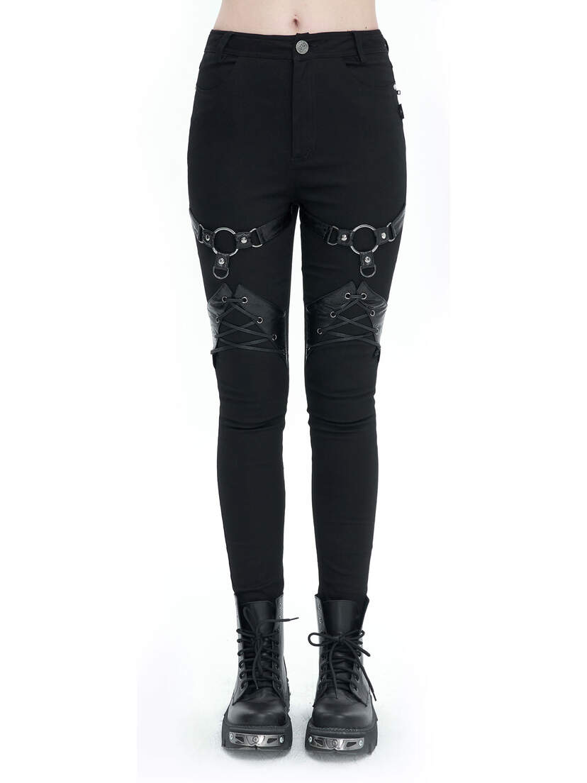 Black harness pants featuring decorative straps and a slim fit, paired with black combat boots.