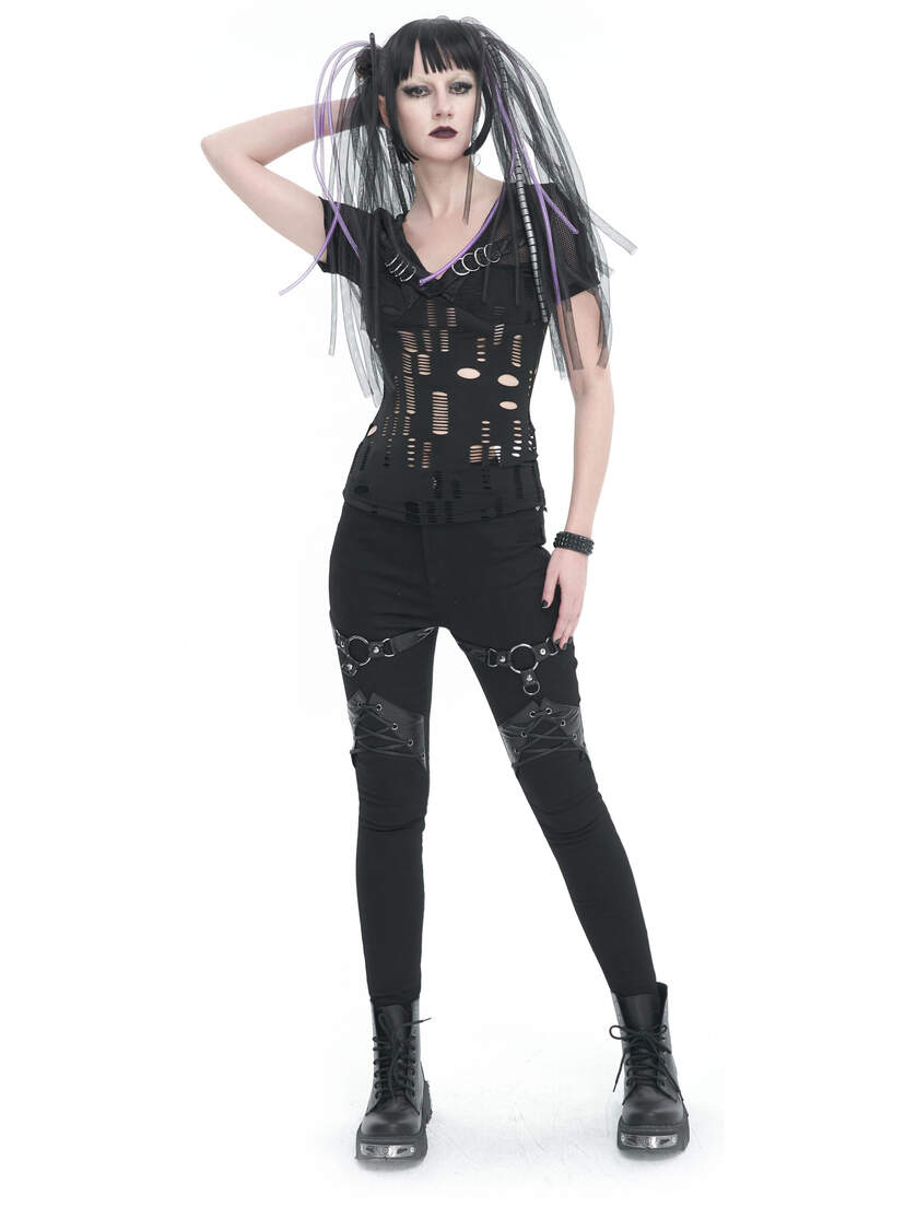 Model wearing black Vivian harness pants with a fitted top and accessories, posing with a hand on hip.
