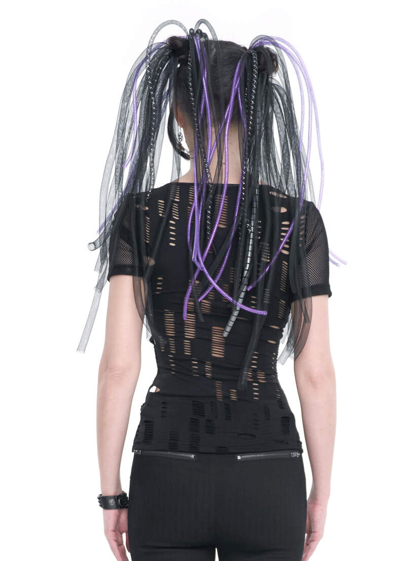 Back view of a black slashed top with a fitted design and colorful hair extensions.