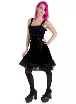 Front view of Emily Strap Dress in black with lace and ruffle details, worn with black tights and platform shoes